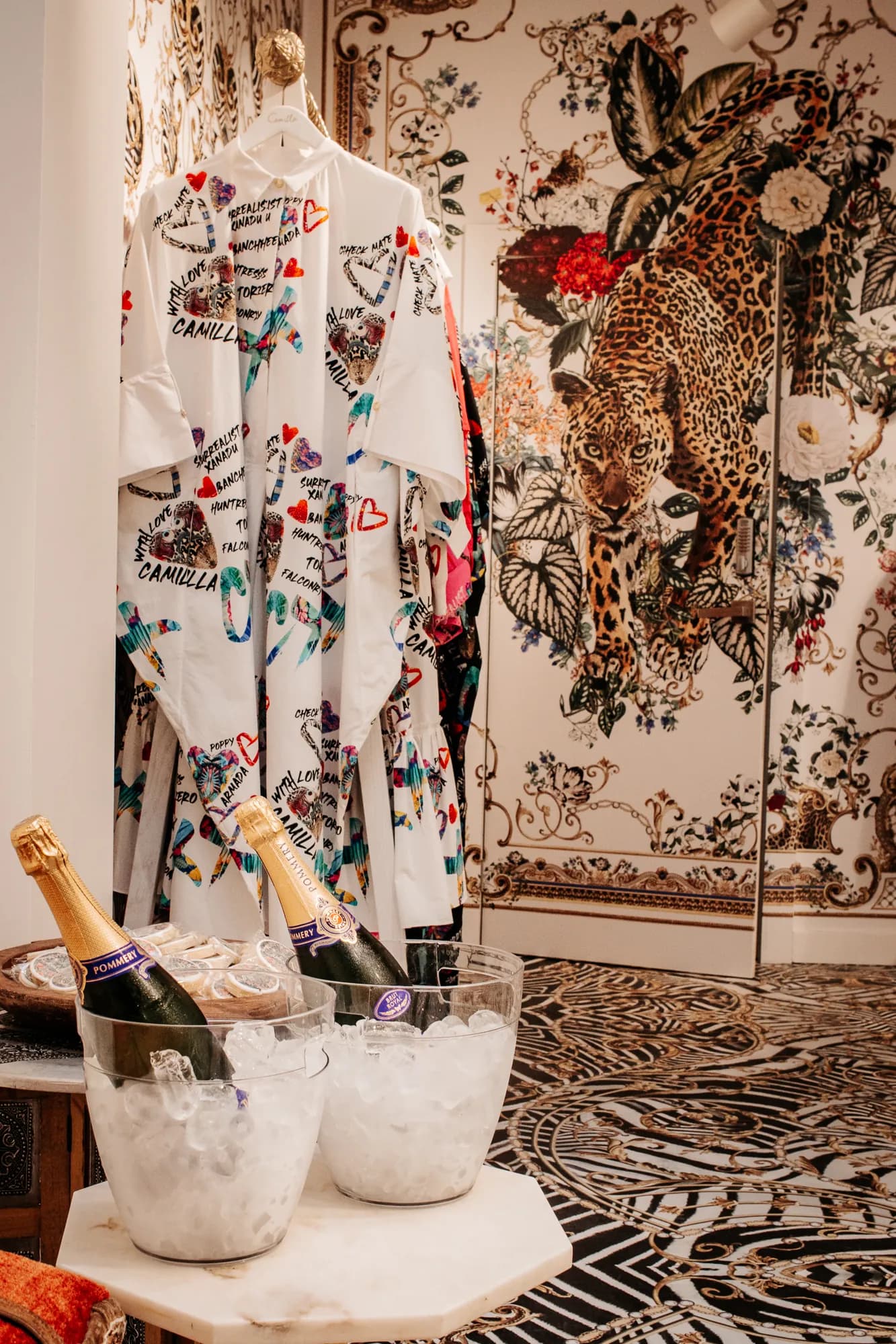 Printed silk garments and champagne styled in the Camilla Armadale store