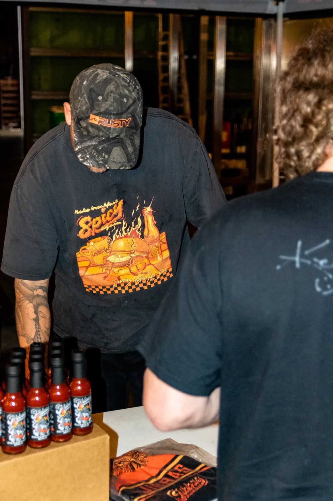 Jibba's Hot Sauce bottles at a tasting table