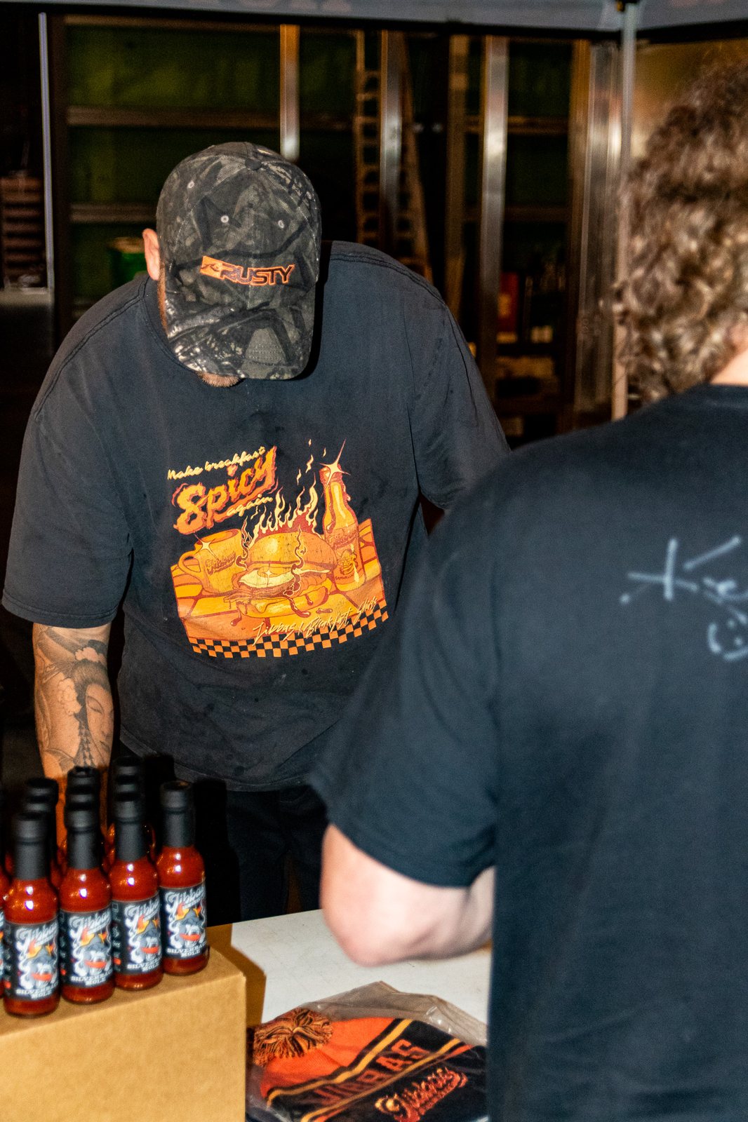 Jibba's Hot Sauce bottles at a tasting table