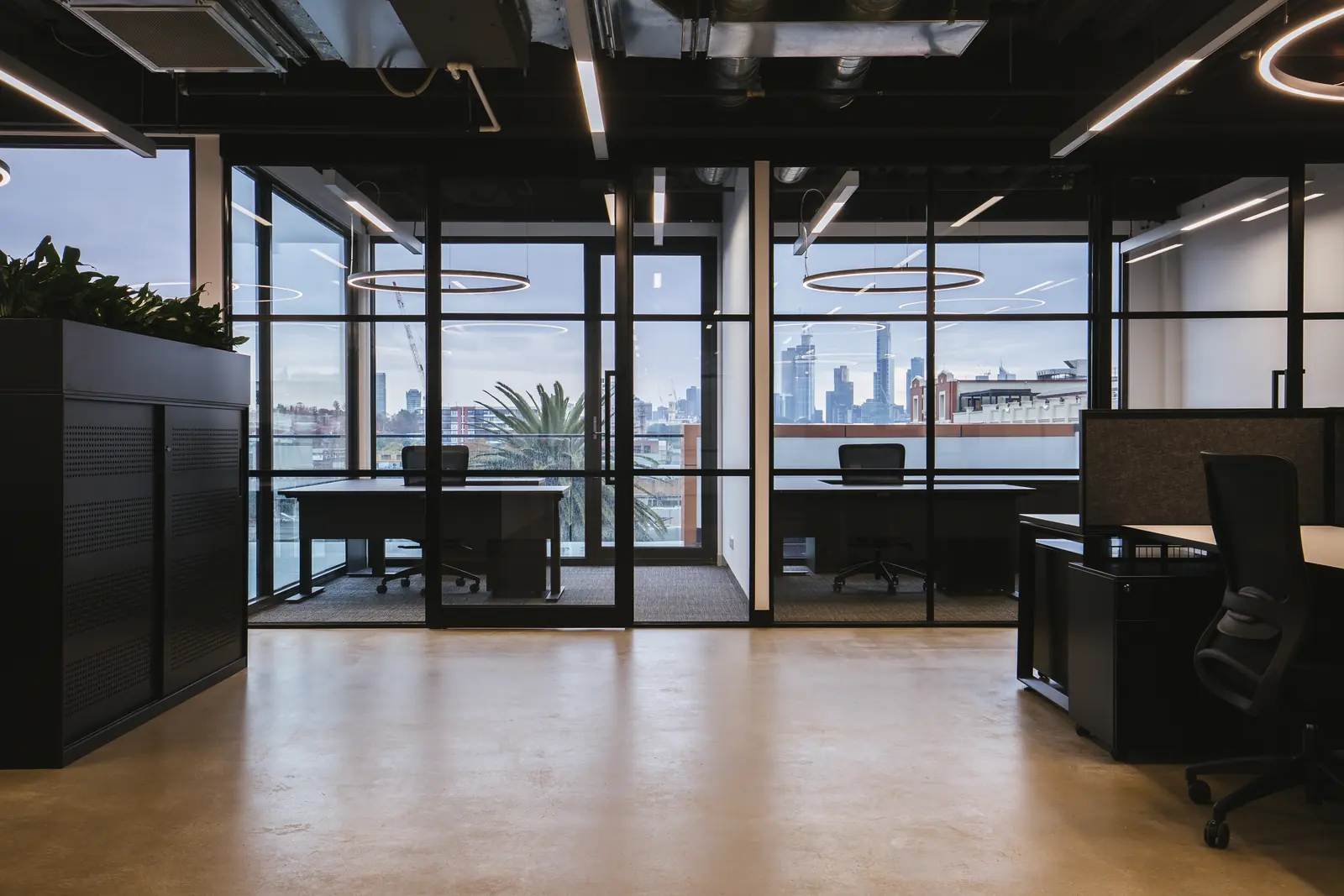 A glazed private office with city views, set off the main floor
