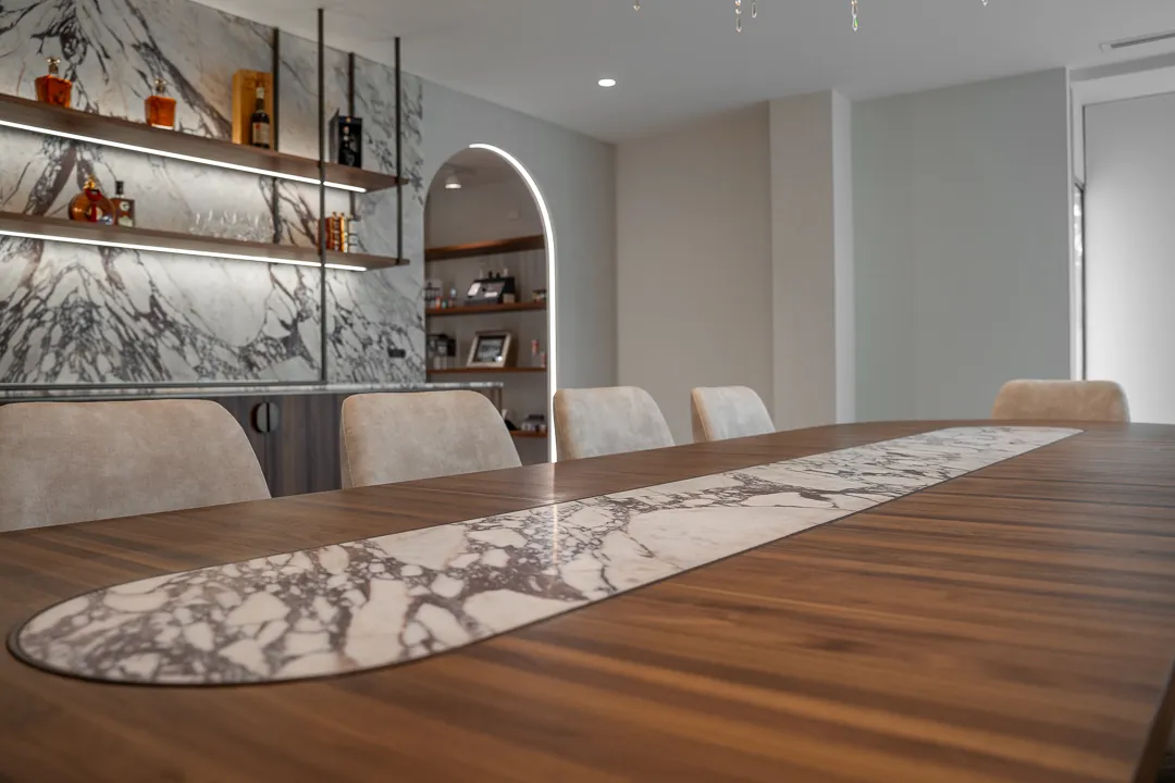 A long marble inlay set into the timber meeting table