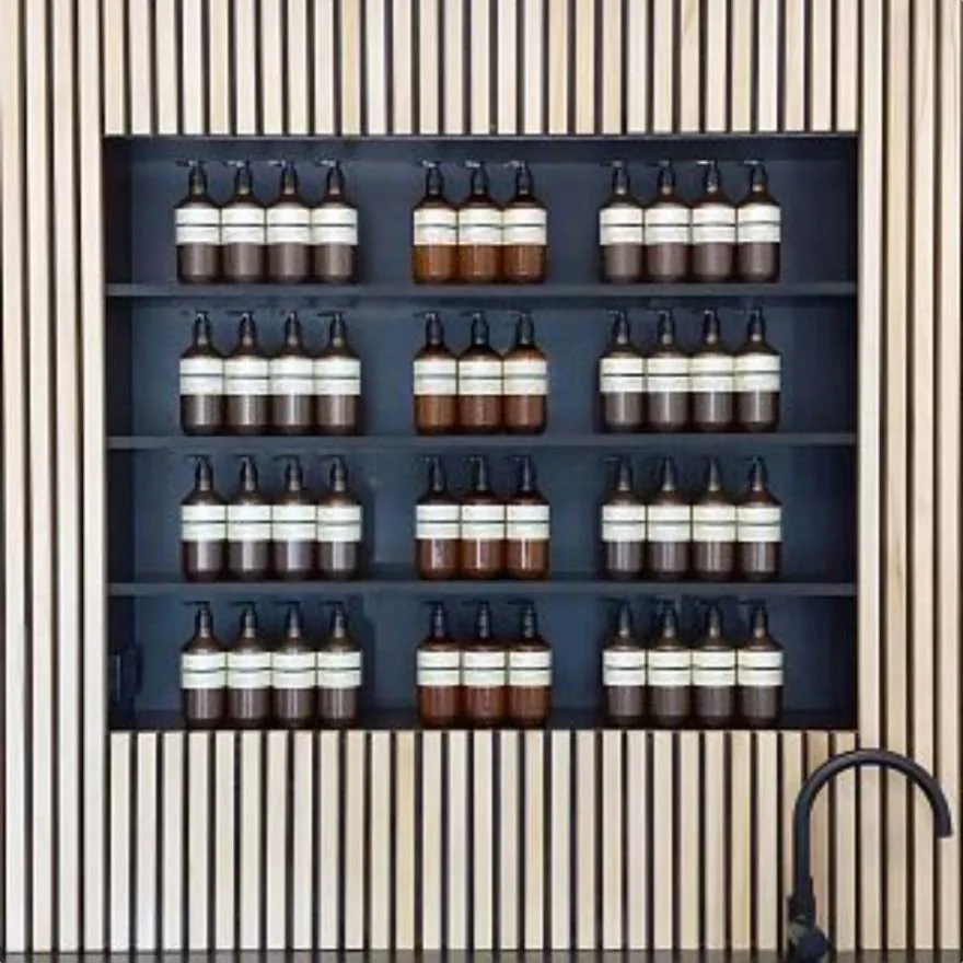 Black product niche set into light timber batten wall